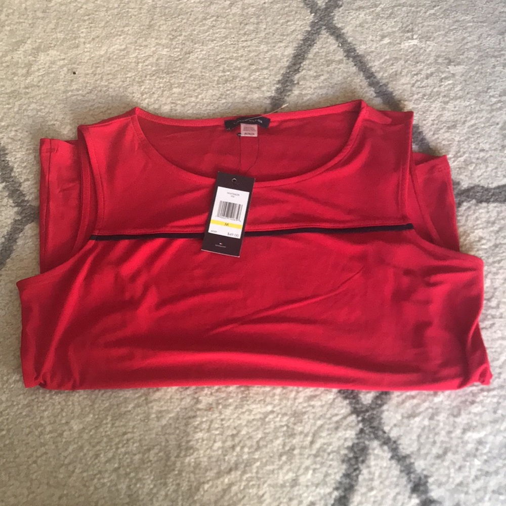 Red sleeveless blouse with black stripe detail.